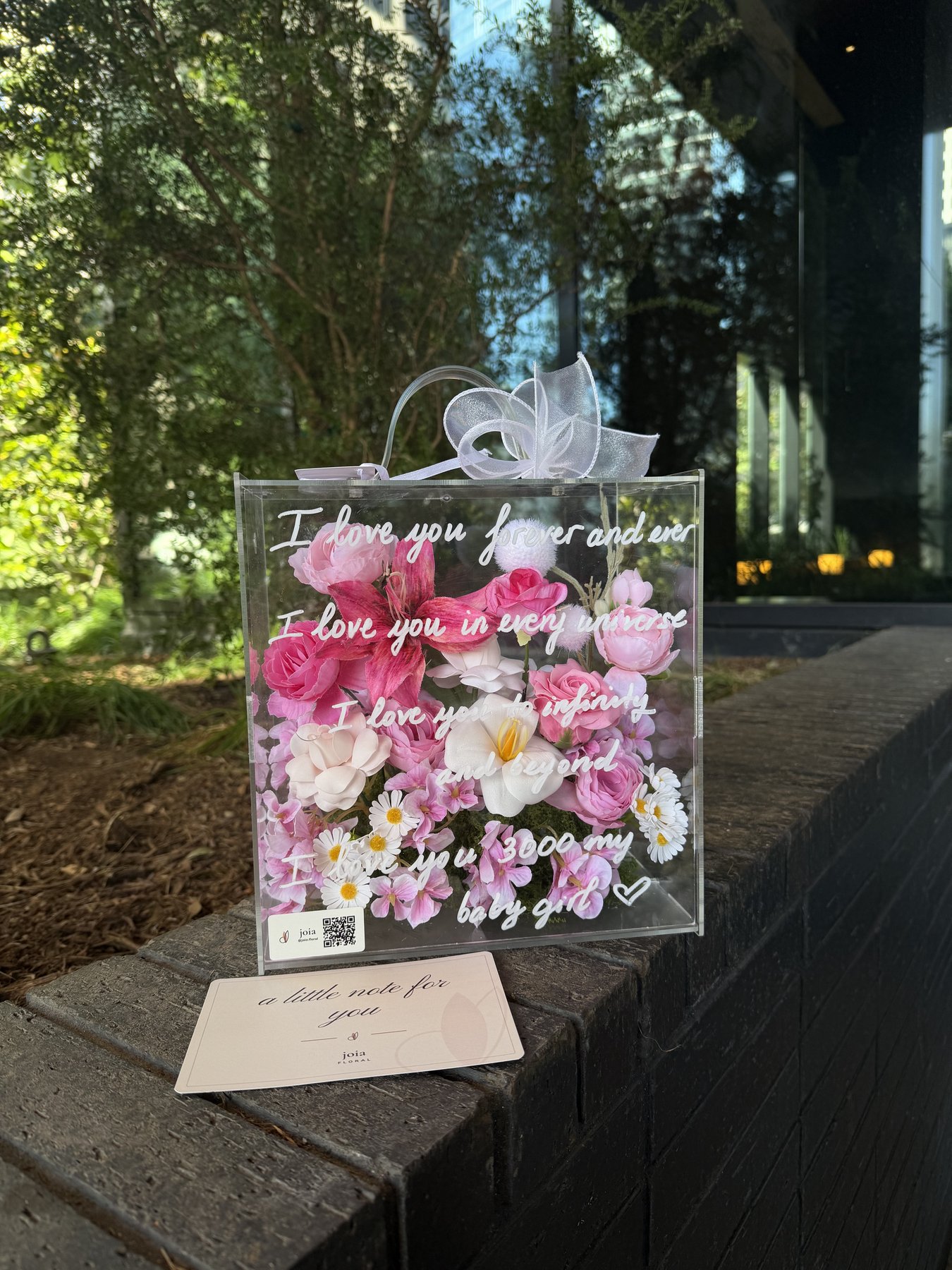 Pink JOIA flower valise with a handwritten style message and matching card